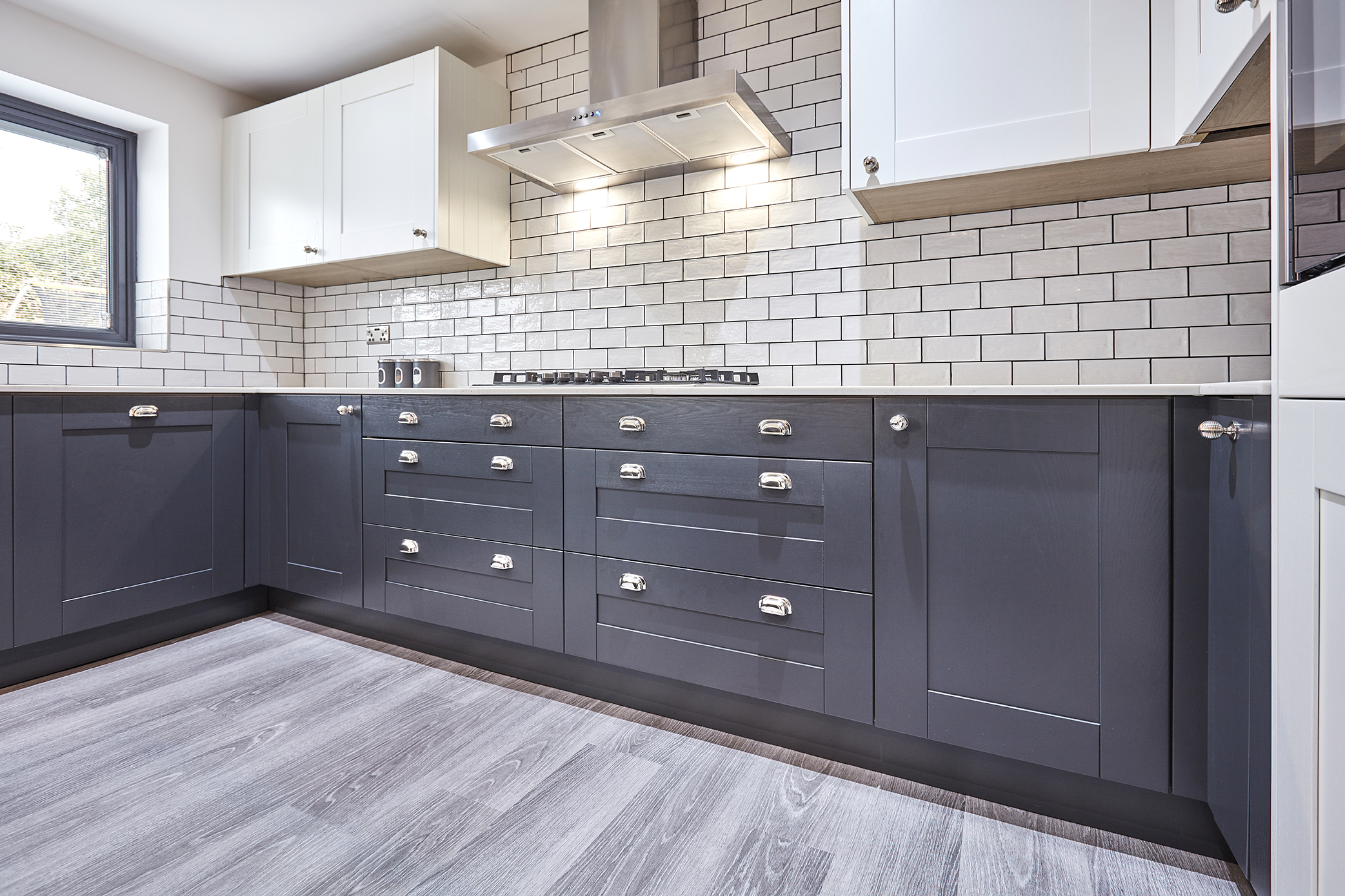 Miele integrated dishwasher concealed within a run of anthracite shaker base cabinetry, Tingley, Leeds.