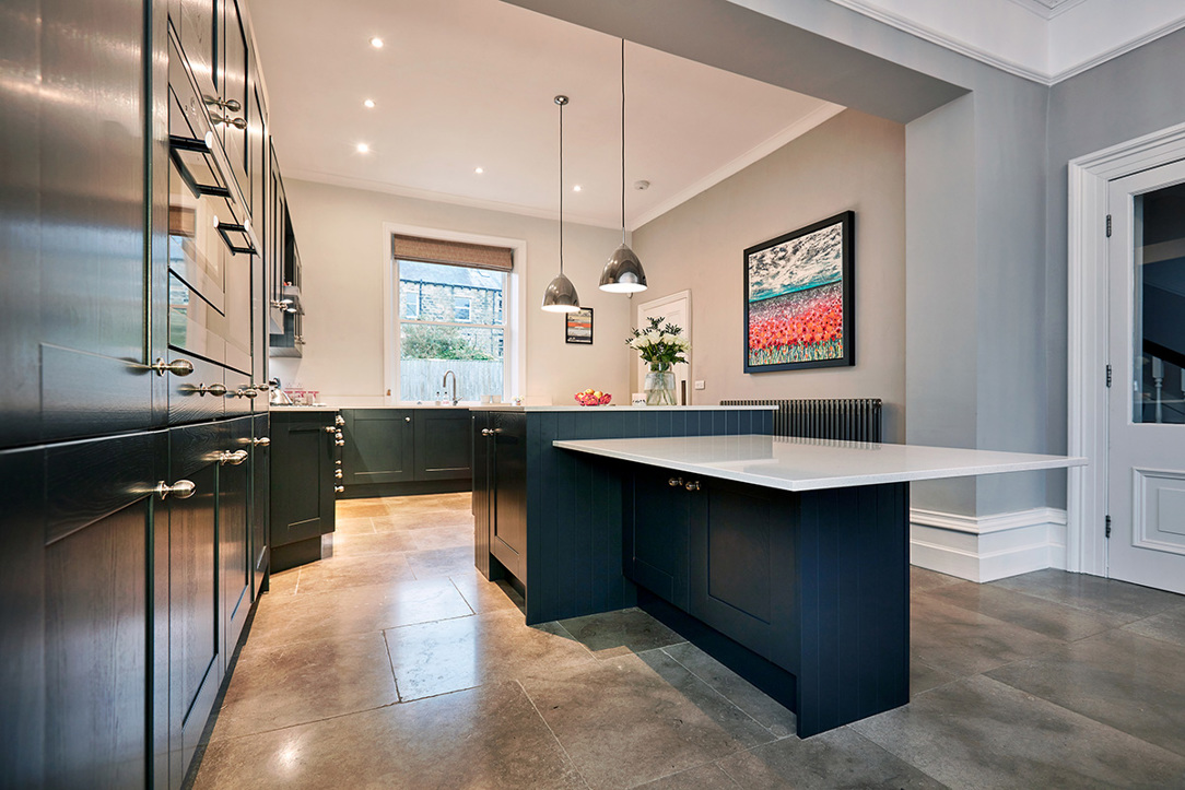 Navy shaker kitchen cabinets and island