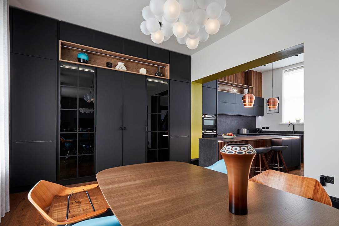 Concealed drinks cabinet in matt black kitchen