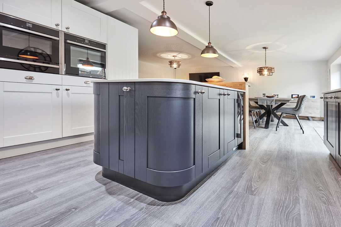 Curved kitchen island with solid oak breakfast bar in Tingley, Leeds